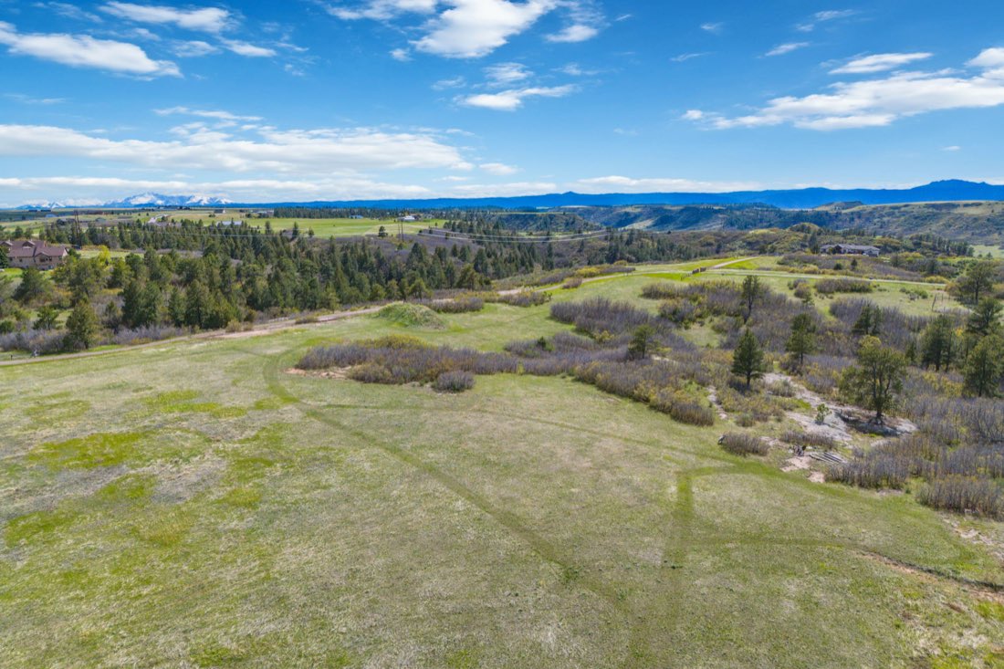Aerial view of the course with snowcapped peaks on the western horizon